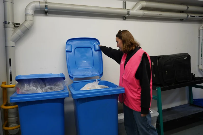 ReSmart driver collecting blue recycling bins from an office