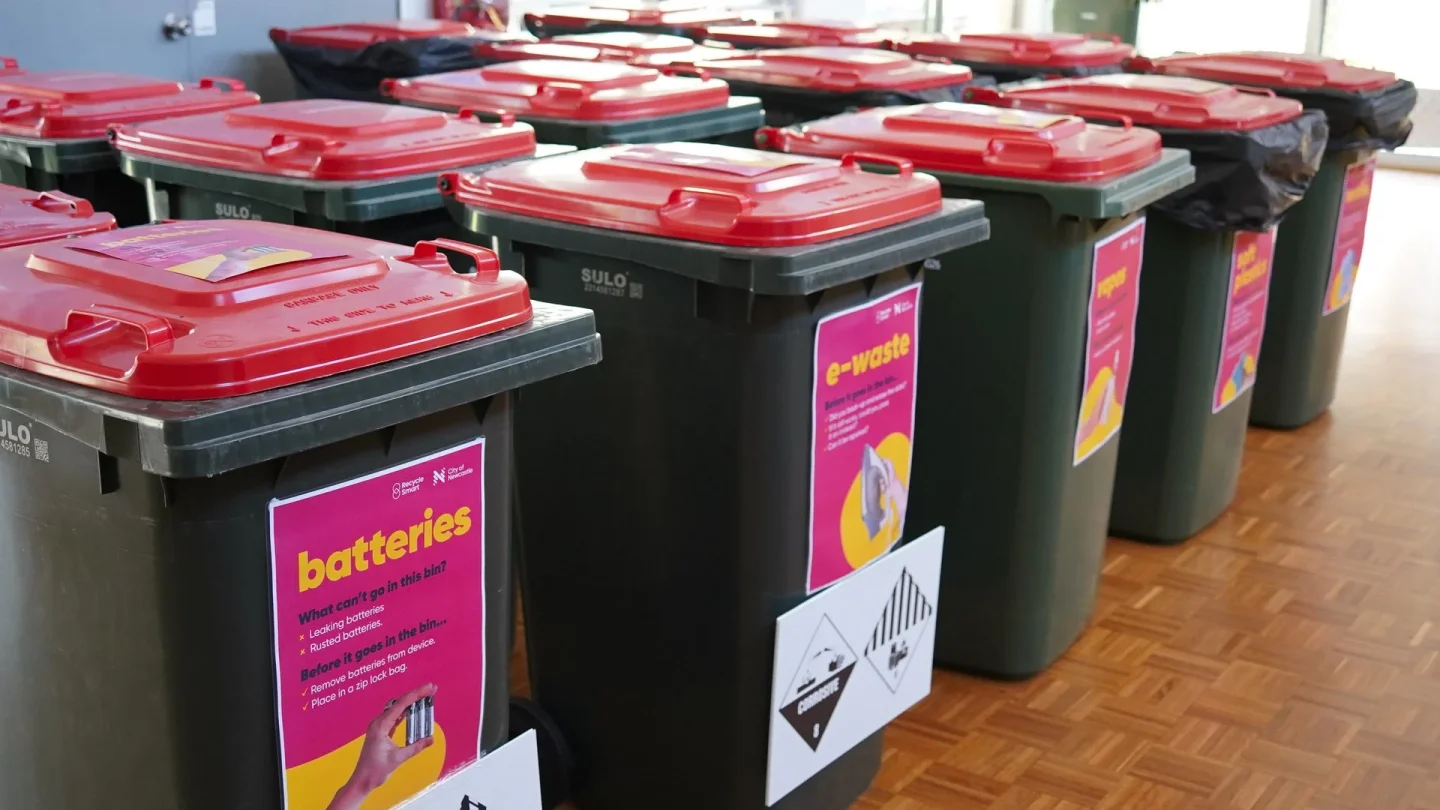 Red-lidded council bins labelled for batteries and e-waste