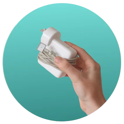 Hand holding a white plug wrapped in a beige extension cord