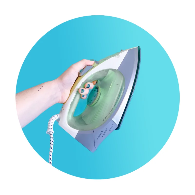 Hand holding a clothes iron