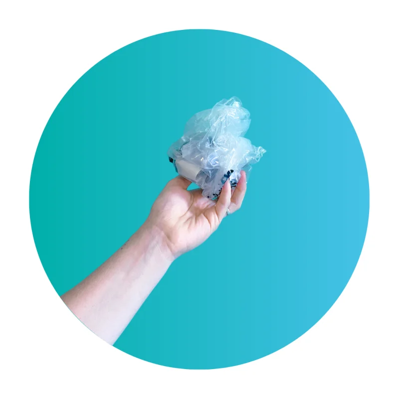 Hand holding a bundle of soft plastic bags